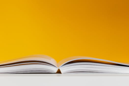 pexels-photo-3760323-3760323 A close-up shot of an open book with a vivid yellow background, perfect for creative and conceptual design.